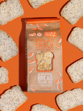Load image into Gallery viewer, Bread SRSLY gluten-free seeded sourdough bread on an orange background with seeded sourdough slices scattered around.