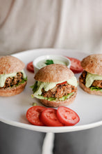 Load image into Gallery viewer, Bread SRSLY gluten-free sourdough Sandwich rolls sliced in half as burger buns. Mushroom patty burgers topped with tomato and aioli on a platter.