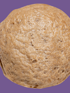 Close up shot of Bread SRSLY gluten-free sourdough sandwich roll on a purple background. Suitable for gluten-free burger buns. 