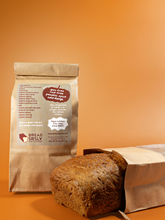 Load image into Gallery viewer, Pumpkin Spice brown paper package with a loaf of bread on an orange background

