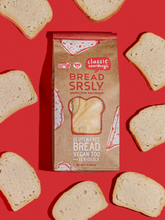 Load image into Gallery viewer, Bread SRSLY gluten-free sourdough on a red background with gluten-free classic sourdough slices scattered around.